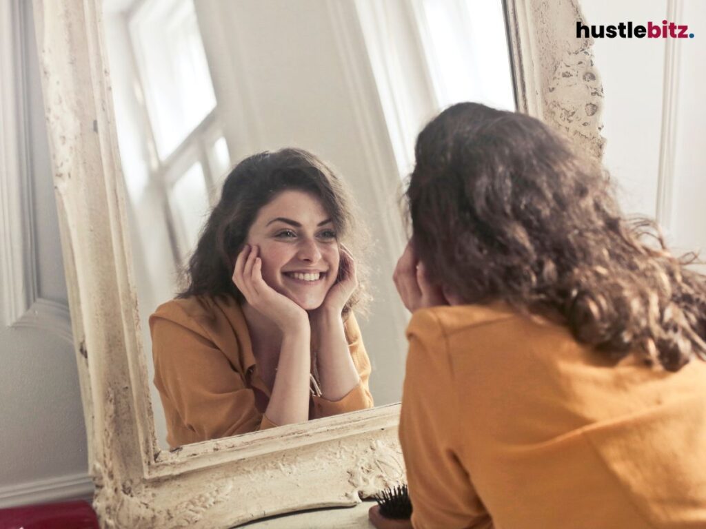 A woman smiling at the mirror.