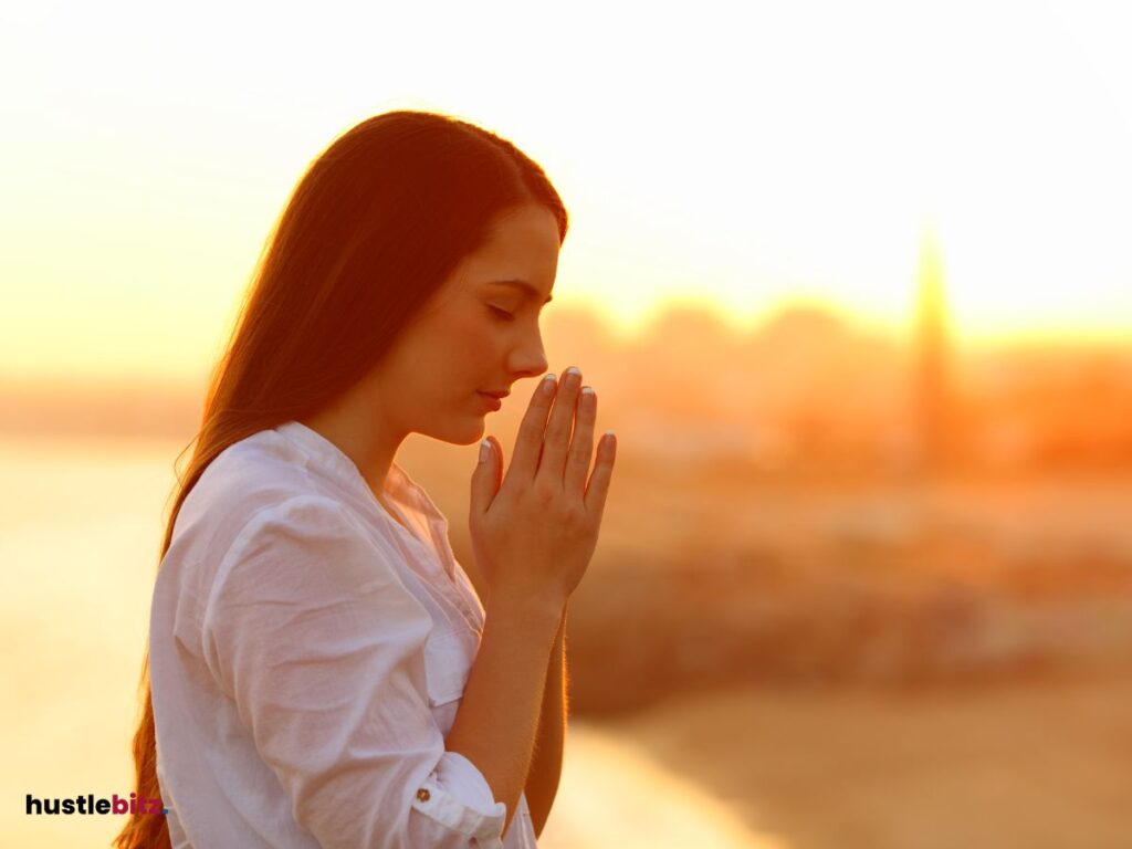 A woman wearing white and doing mindfulness