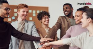 A group of people smiles to each other inside the office