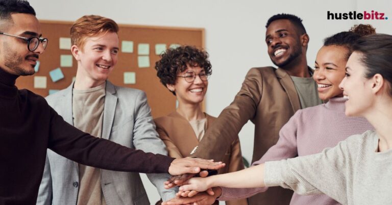 A group of people smiles to each other inside the office