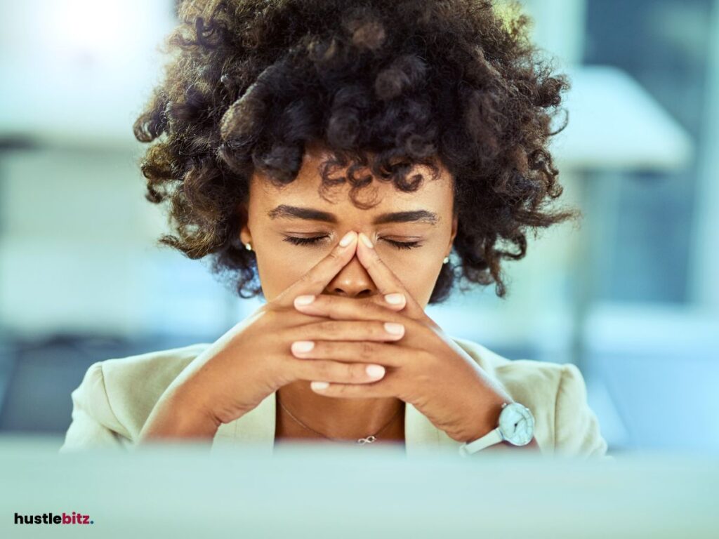 A woman pinching her nose, closing her eyes showing a sign sleepiness.