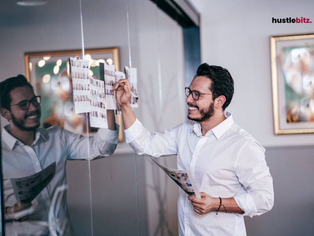 A man smiles in front of the mirror holding a paper