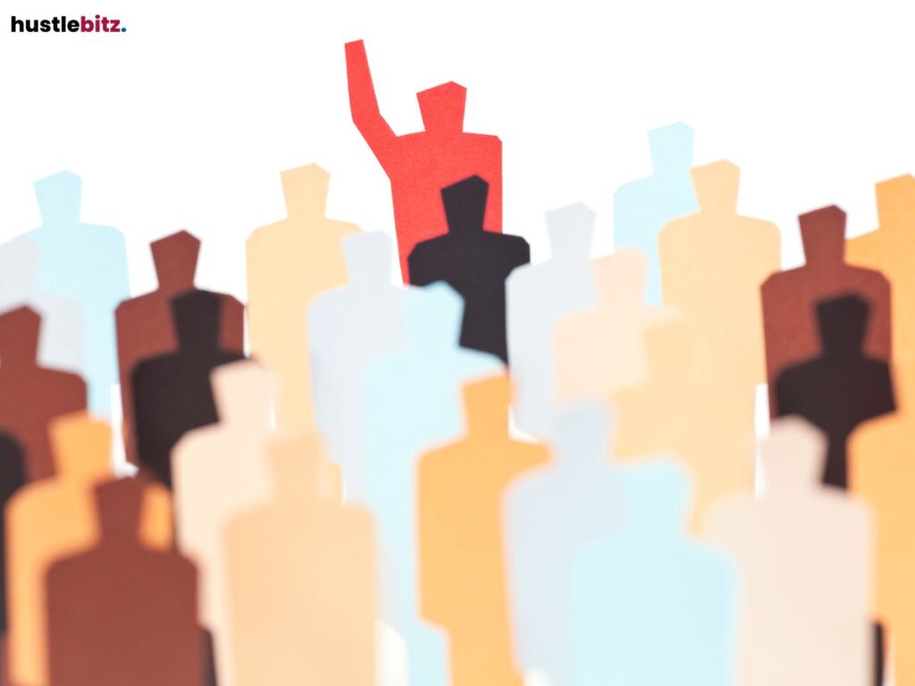 A red figure standing out in a crowd of neutral-colored people cutouts.