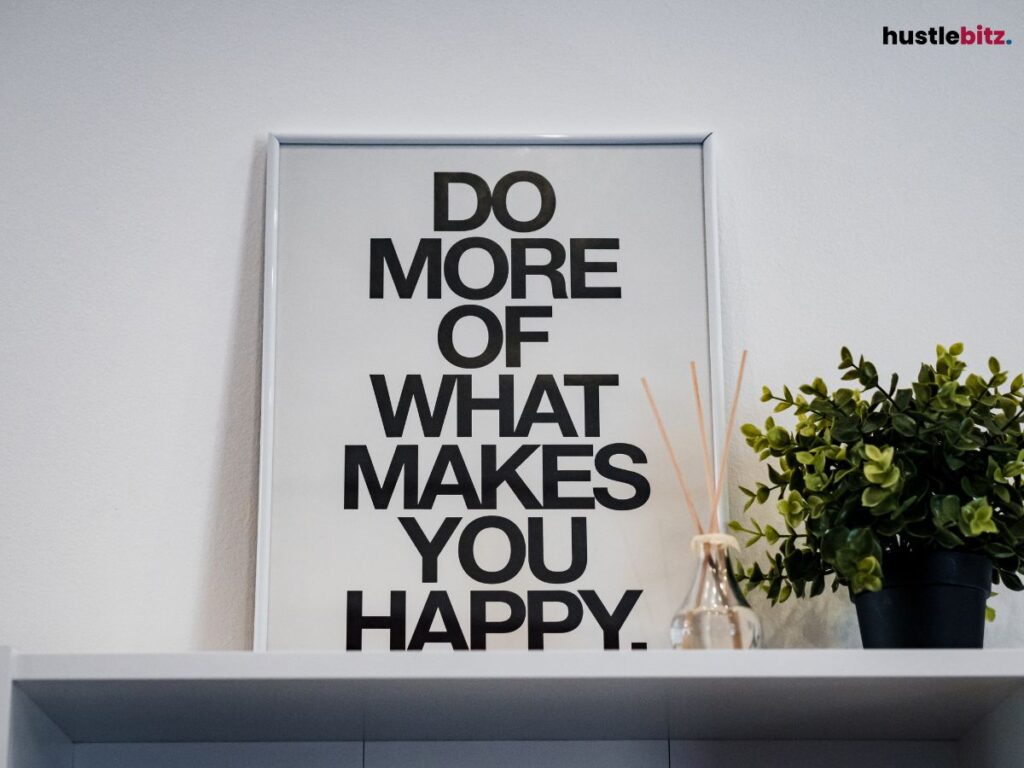 A framed poster reading "Do more of what makes you happy," in a minimalist setting.