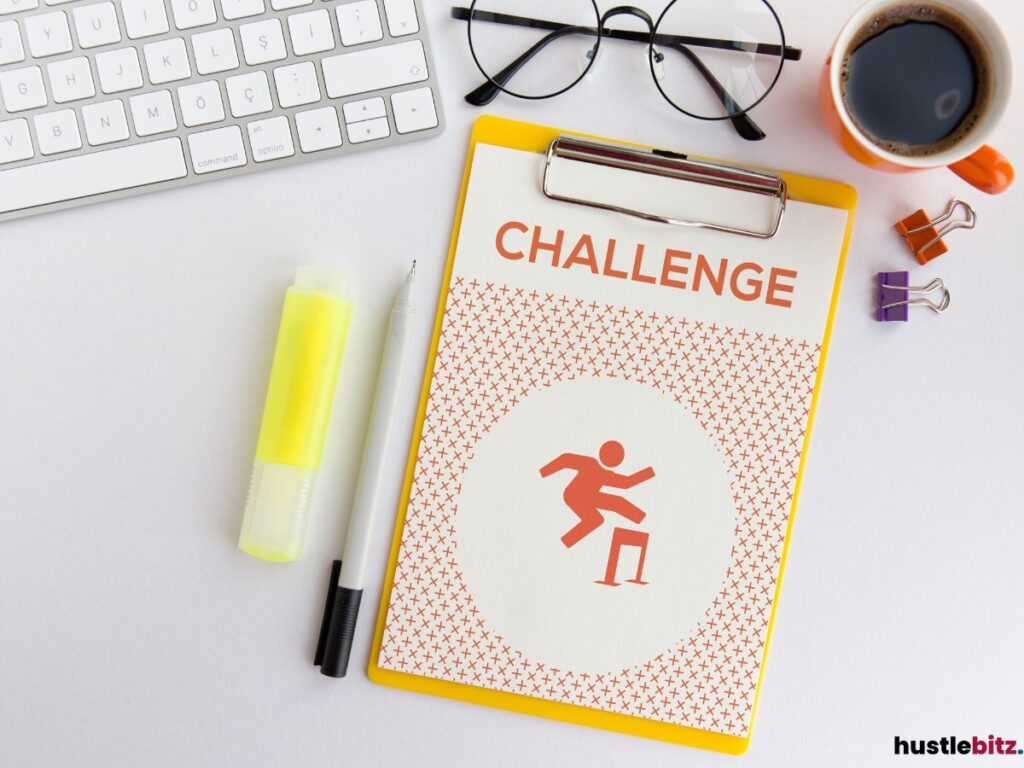 Clipboard with the word "Challenge" beside a keyboard, glasses, coffee, and stationery.