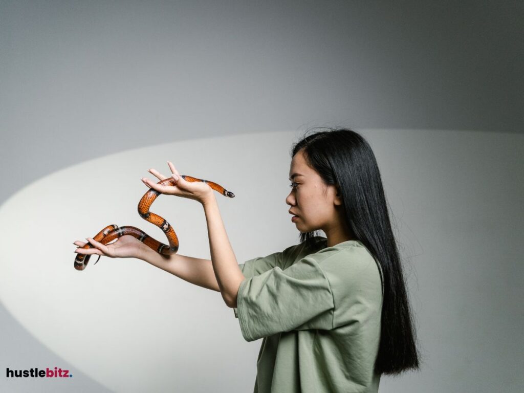 A woman holding a snake.