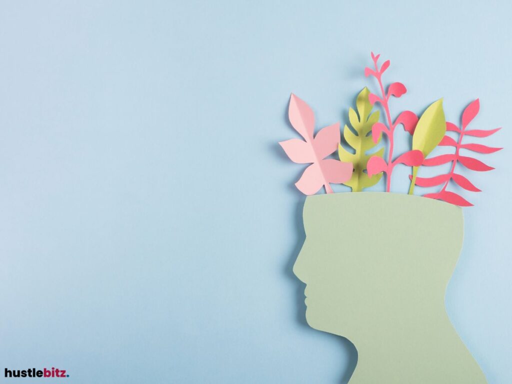 Paper cutout of a head with colorful plants growing from it.