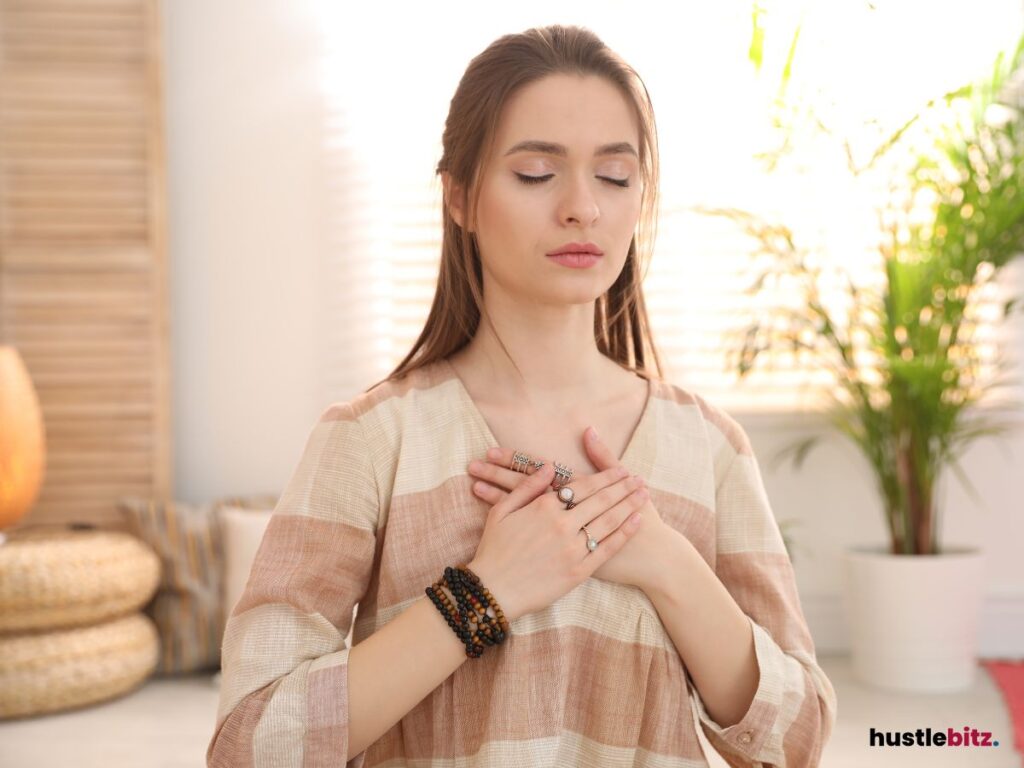 Woman meditating with hands on her heart.