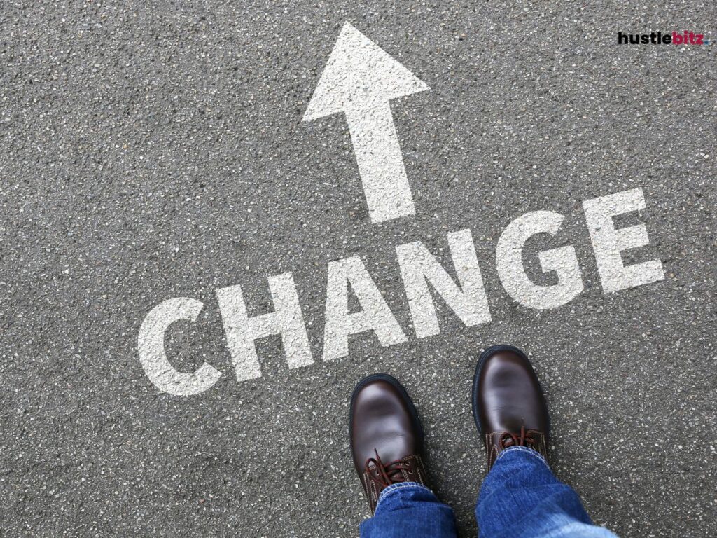 A person stands on pavement with the word "CHANGE" and an arrow pointing forward.