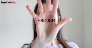 A hand with "ENOUGH" written on the palm.