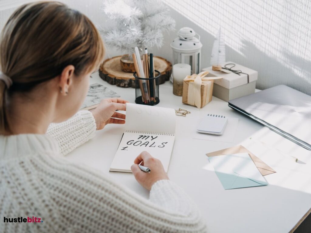 A woman doing writing about her goals inside the room