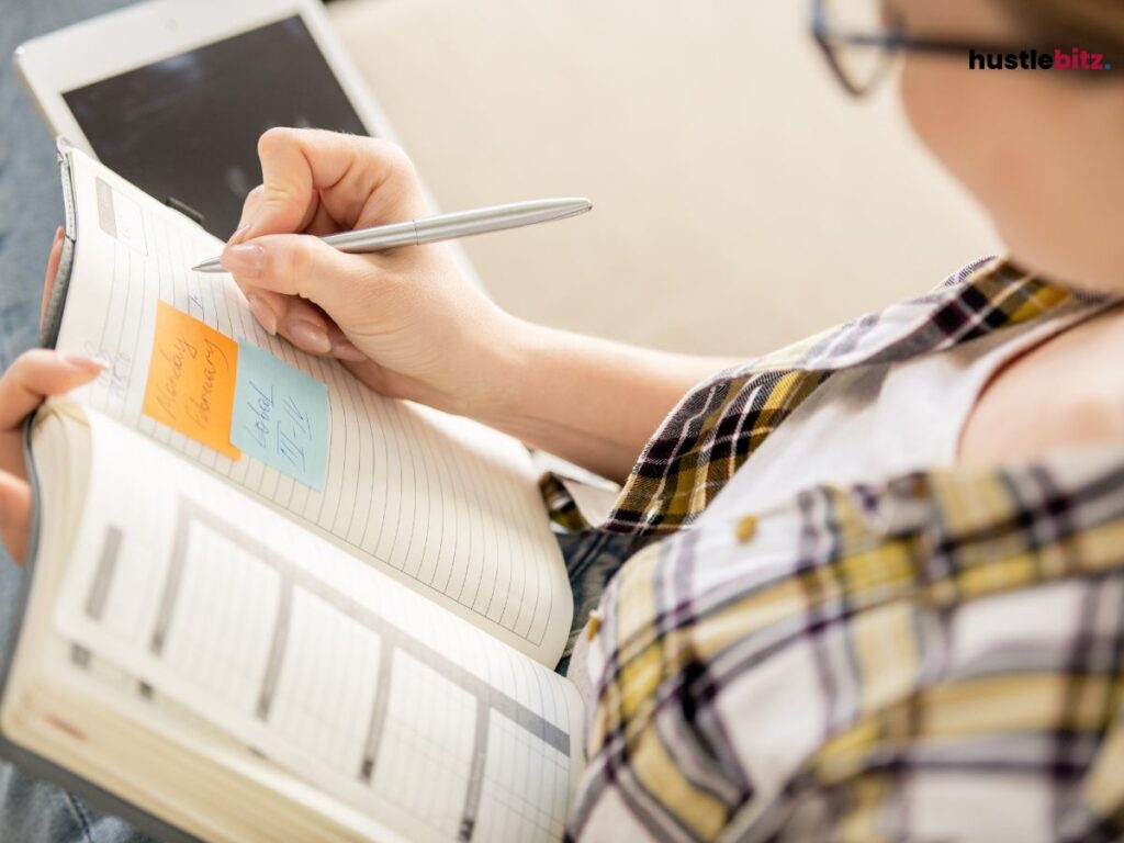A woman writing in the notebook 