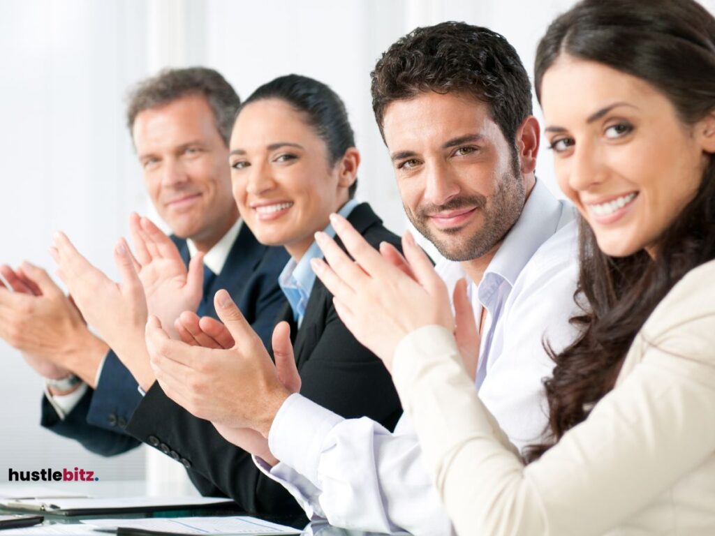 A group of office workers clapping thier hands showing support.