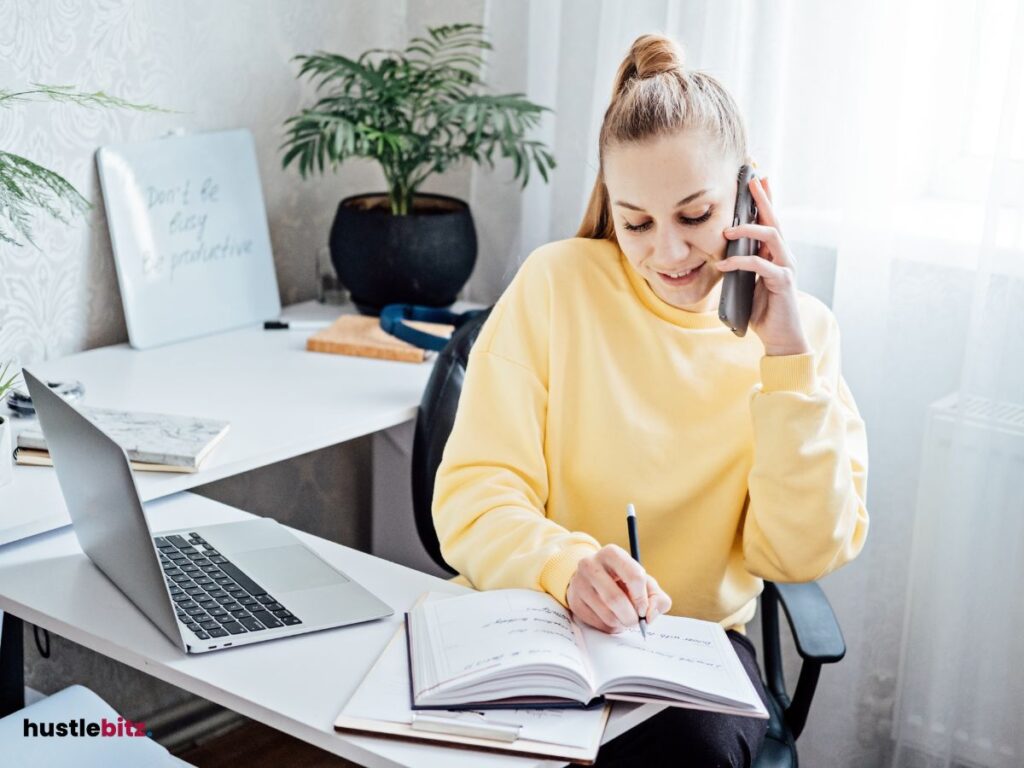 A woman doing calling and writing