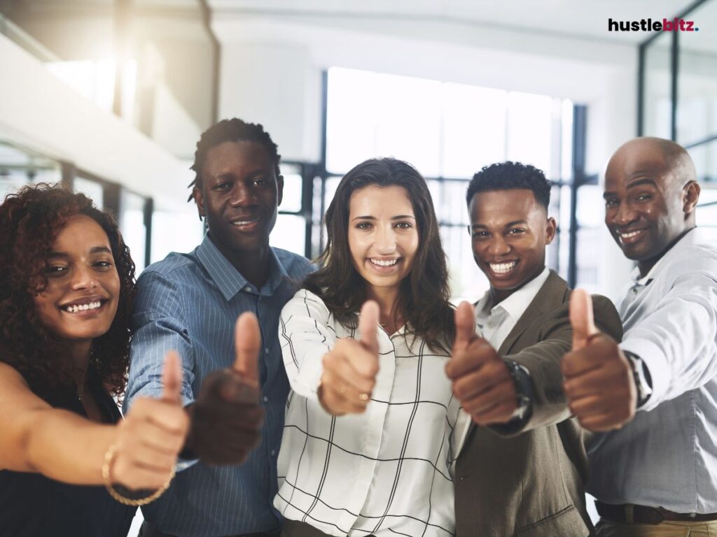 A group of people smiles and thumbs up