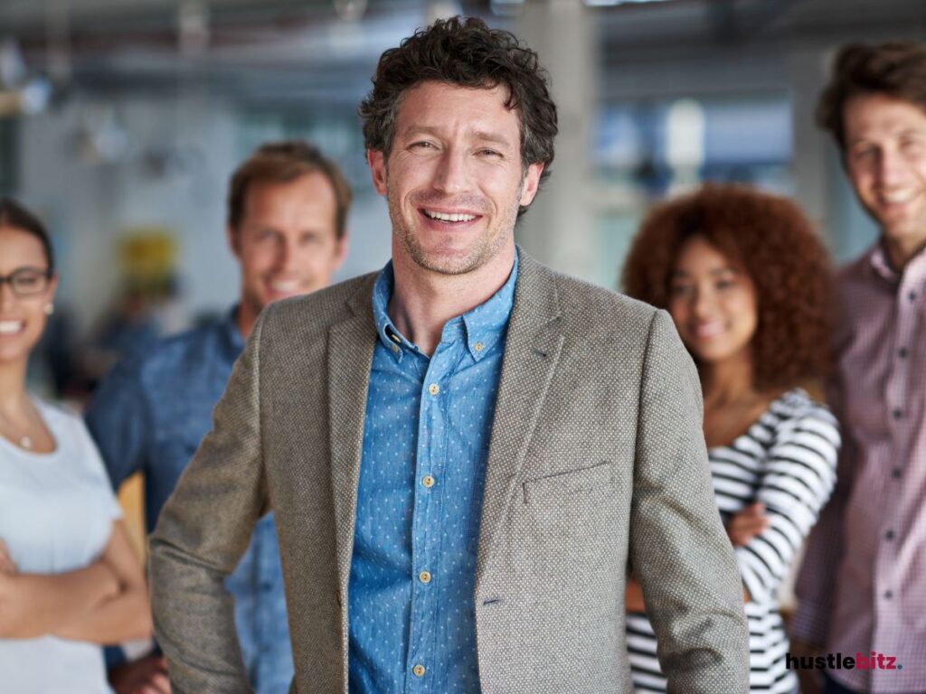 A man smiles and group of people background