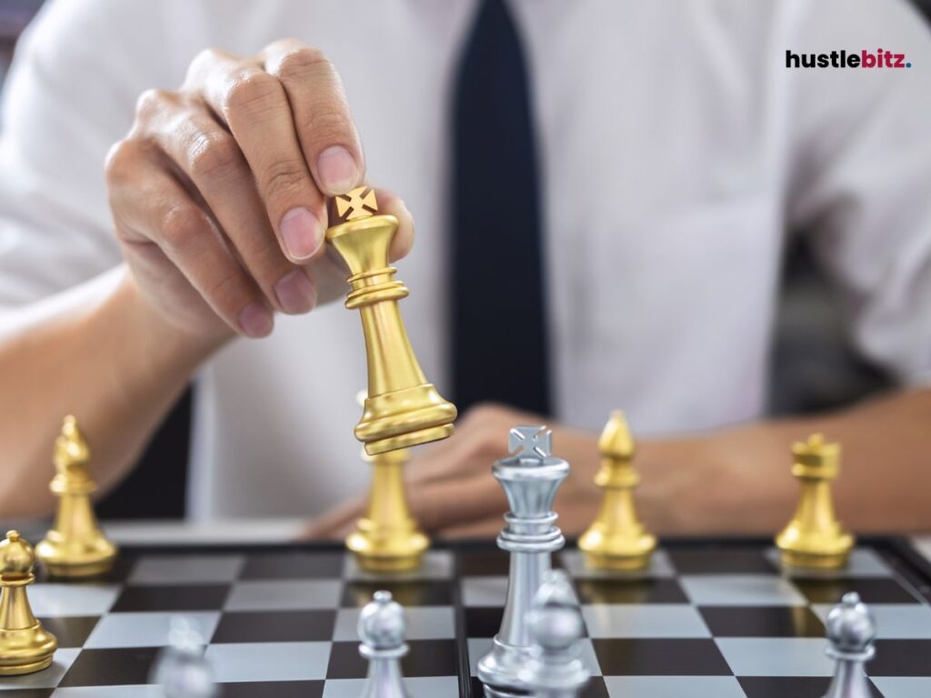 A man playing chess taking turn and moving the king.