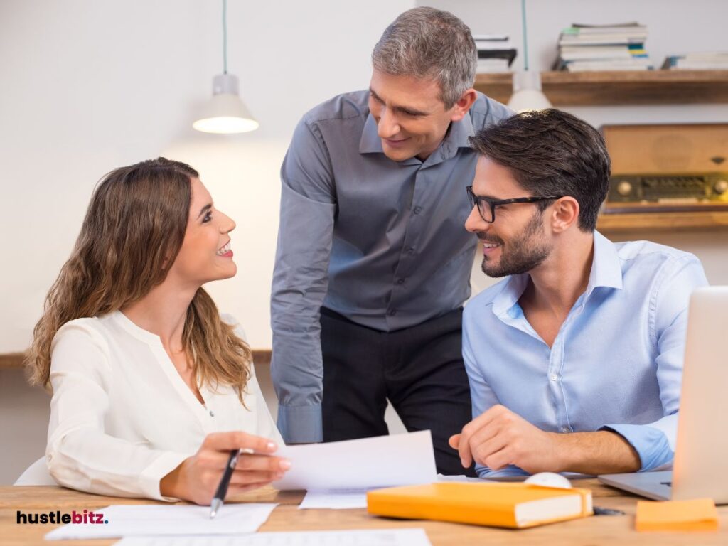 Three people inside the office smiles