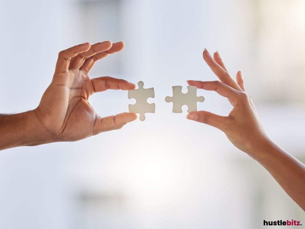 Two persons combining two puzzle piece.