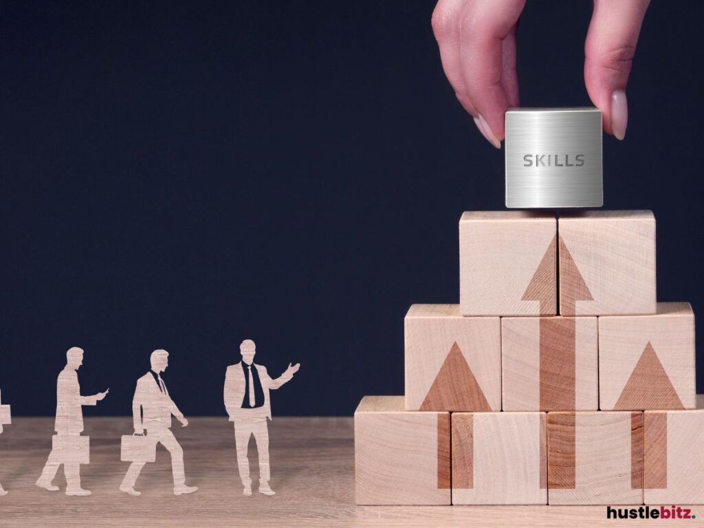 A hand placing a metallic block labeled "SKILLS" on top of a pyramid of wooden blocks.