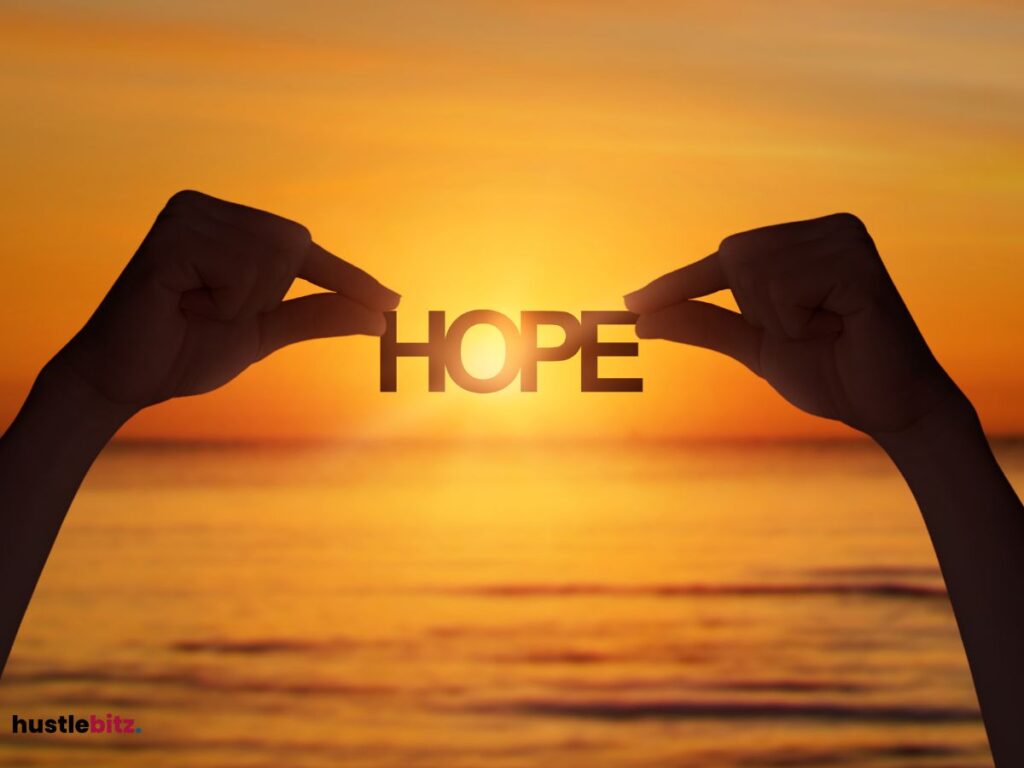 A hand holding a word "HOPE"