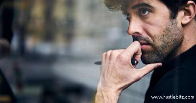 Thoughtful man looking out of a window, reflecting deeply.