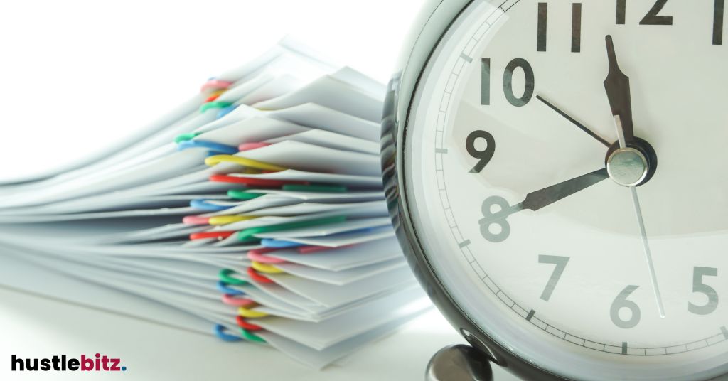A clock and stack of papers.
