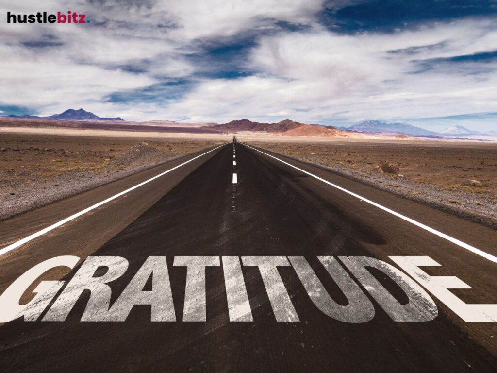 A long desert road with the word "GRATITUDE" written on it.