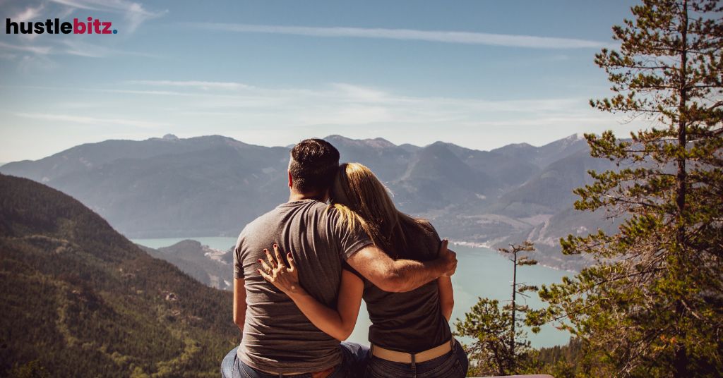 A couple sitting in front of the mountain