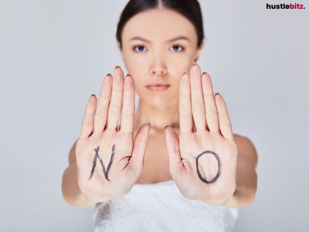 A woman showing her palm with the word "NO".