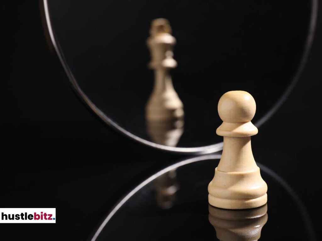 A chess pawn looking at its reflection, which shows a king.