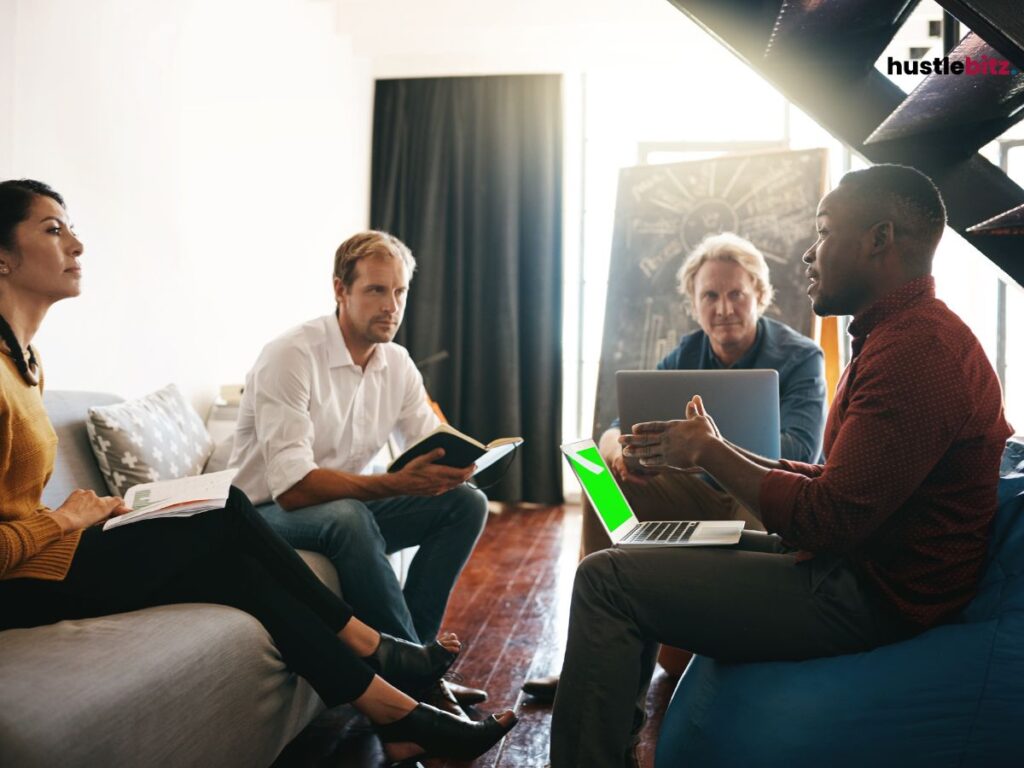 A group of people sitting while listening to the man talking