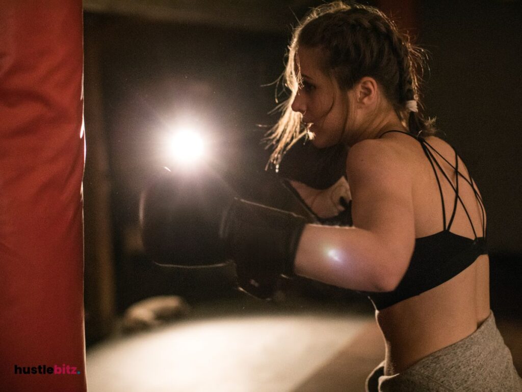 A woman practicing boxing, with intense focus and determination.