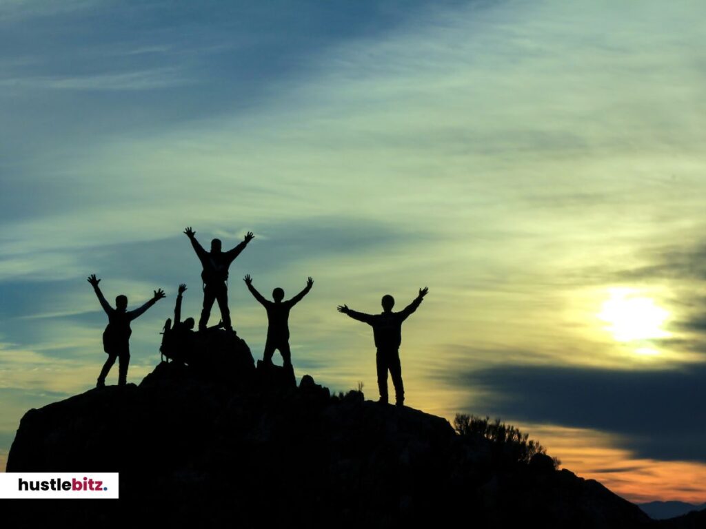 A group of people standing above the mountain
