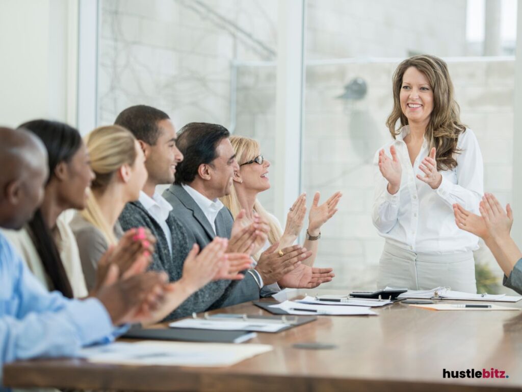 group of people clapping inside the office