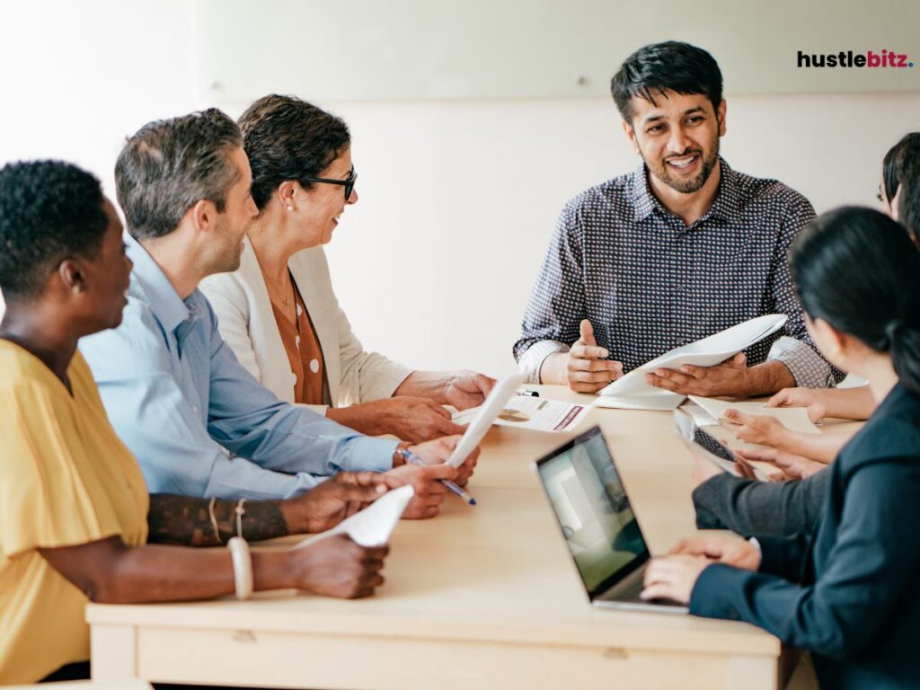 A group of people sitting and holding paper