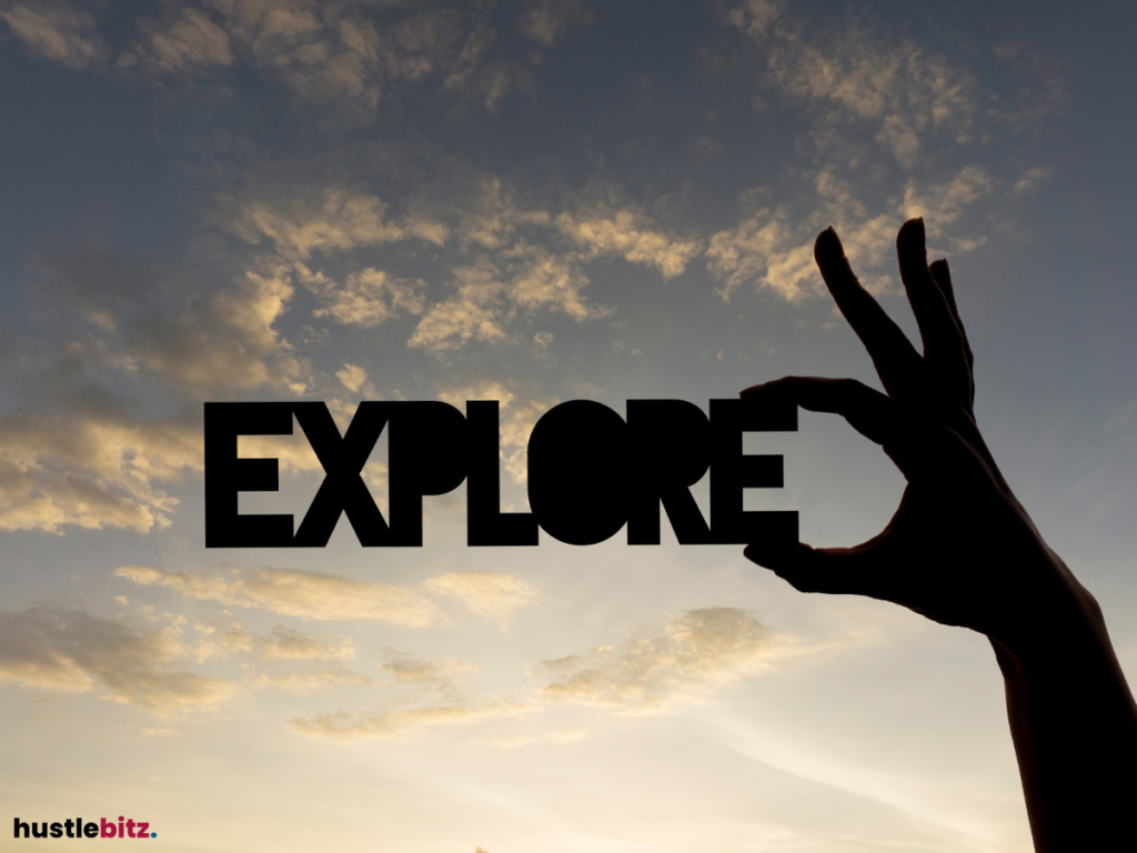 A silhouetted hand holds the word "EXPLORE" against a sunset sky.