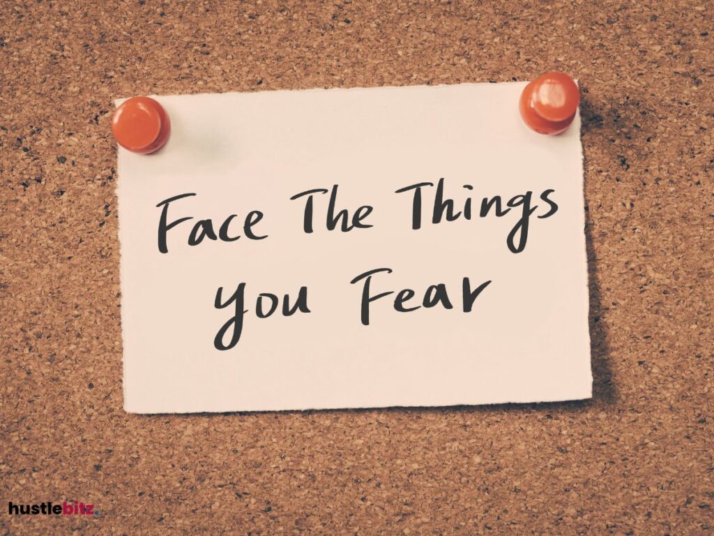 A note on a corkboard with the words "Face the Things You Fear".