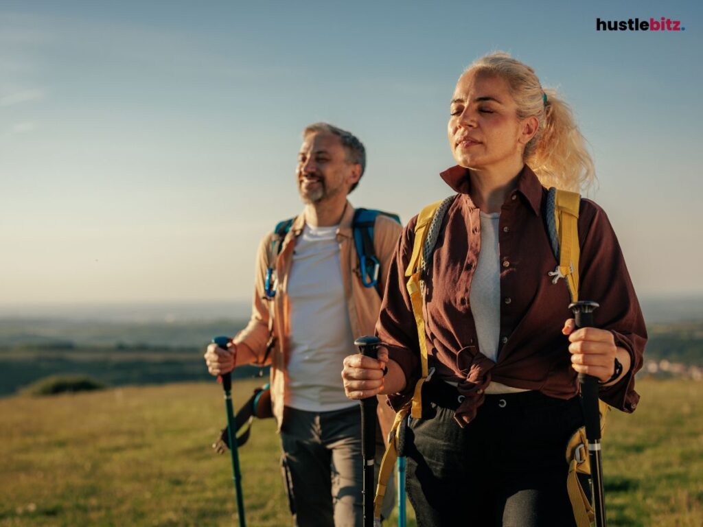 Two people hiking with trekking poles, enjoying the outdoors.