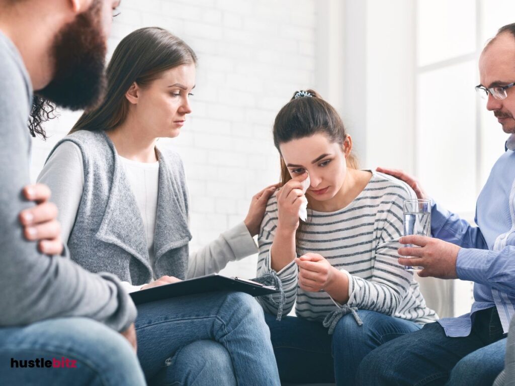 A group of people comforting the women