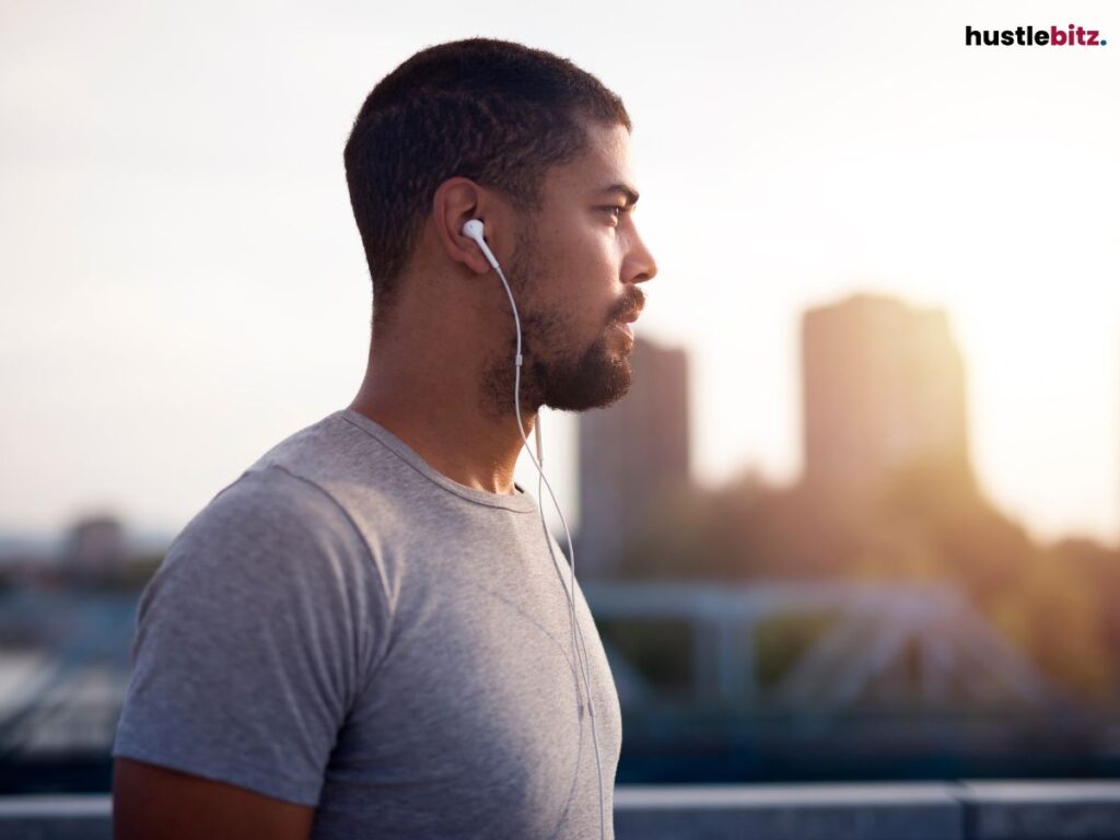 A man wearing headphones in a city setting.