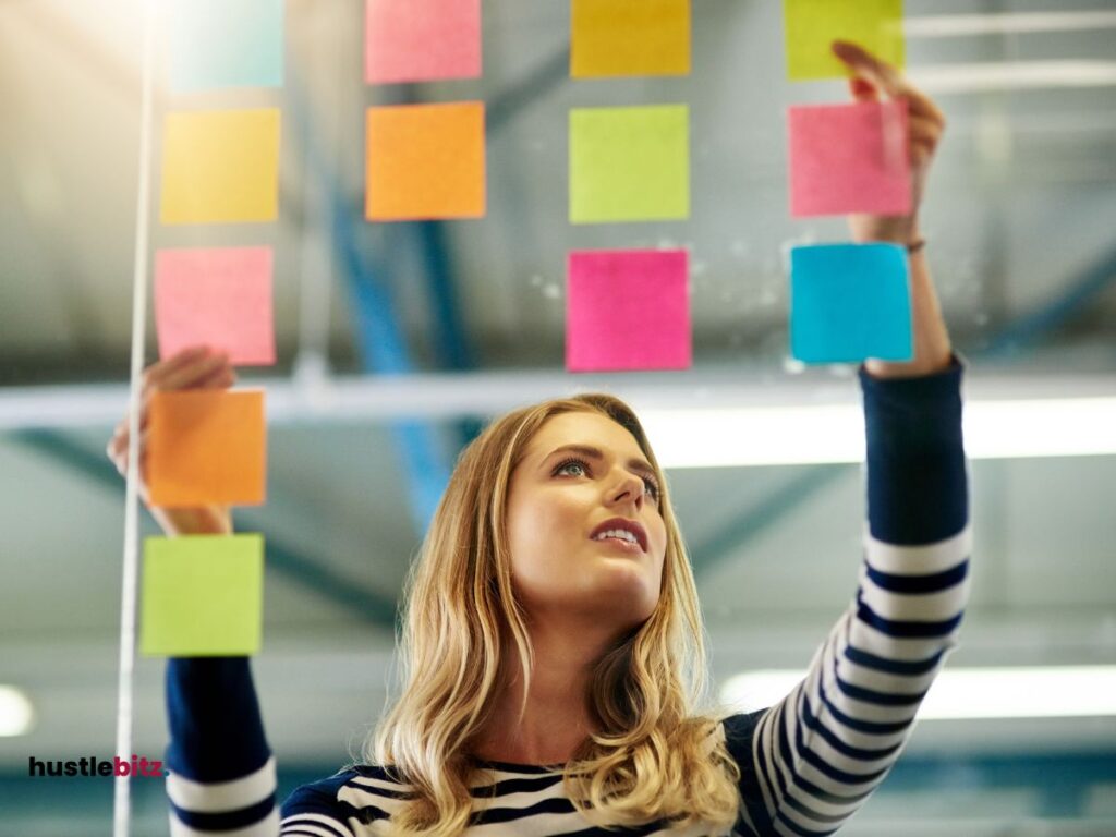 a woman holding two sticky notes