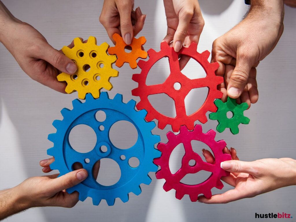 Hands holding colorful gears.