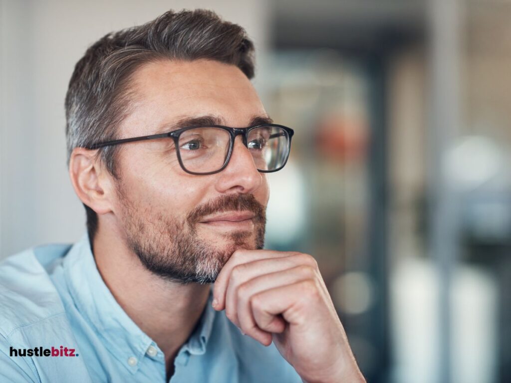 A man wearing eyeglass smiles 