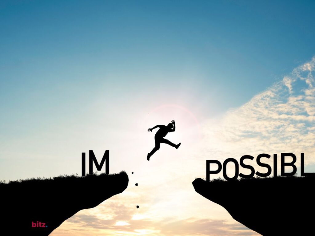 A man jumping between two rocks with word 