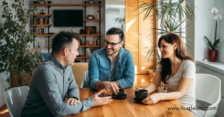 three people talking inside the office