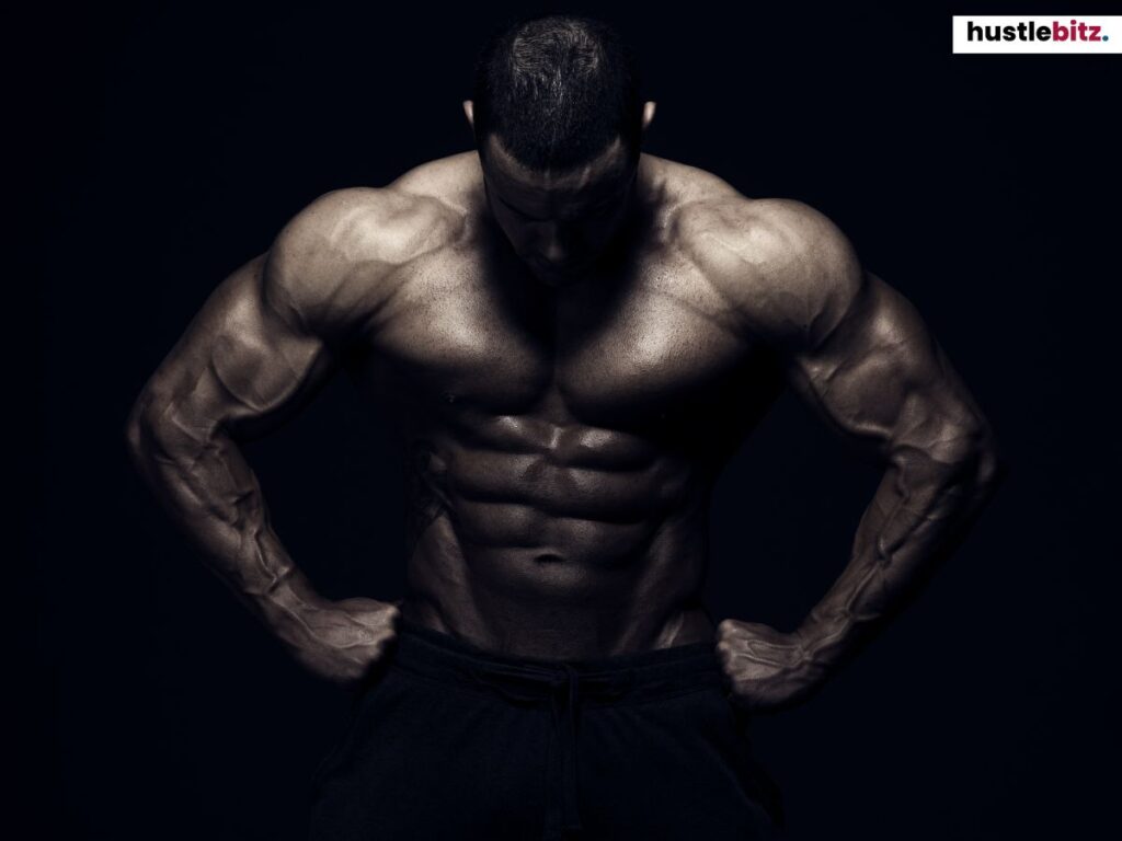 A muscular man showcasing his physique, posing against a dark background.