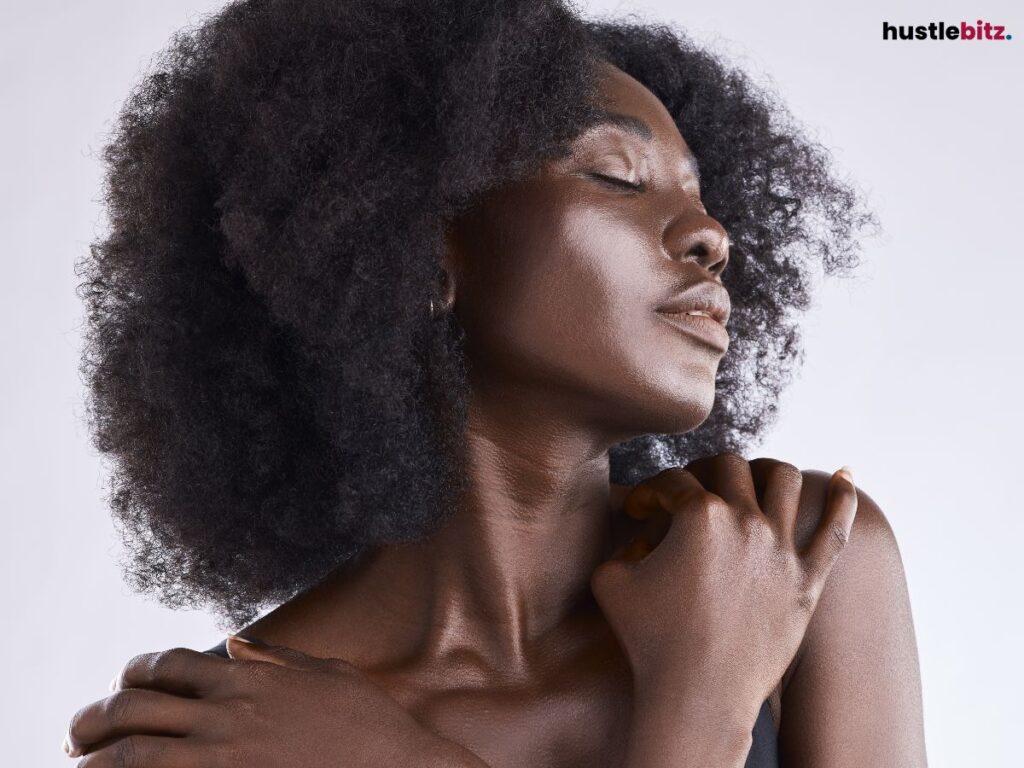 A woman closing her eyes and embracing herself.