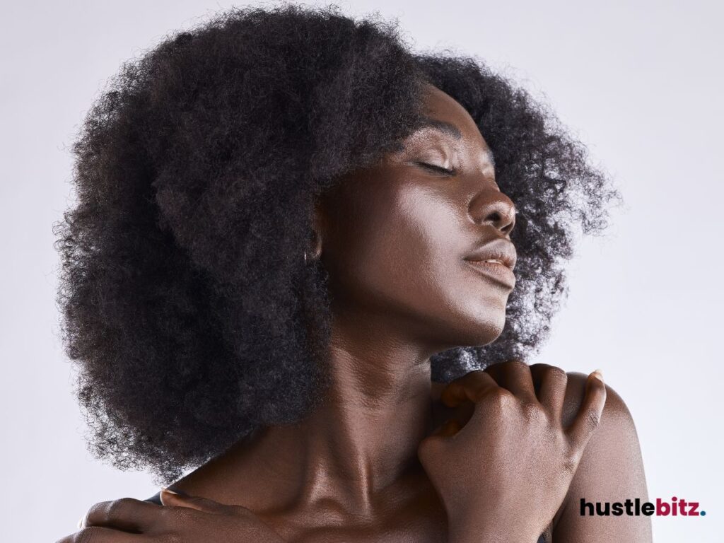 A woman closing her eyes and embracing herself.