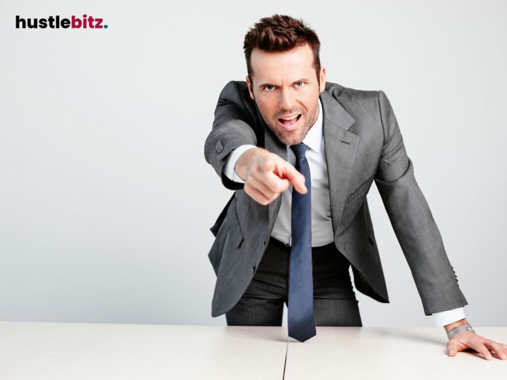 A man in a suit points forcefully, symbolizing authority and determination.